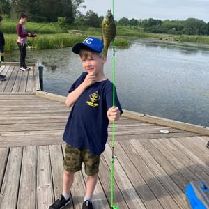 Cub Scout Holding caught fish