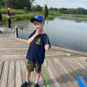 Cub Scout Holding caught fish