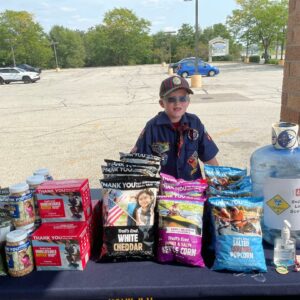 Cub Scout selling popcorn