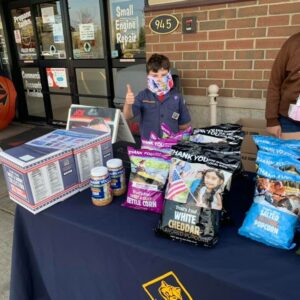 Cub Scout selling popcorn