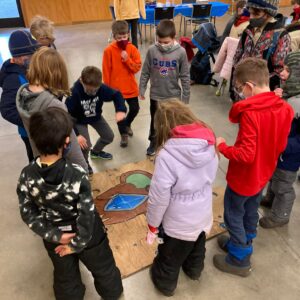 Cub Scouts working on an outdoor puzzle